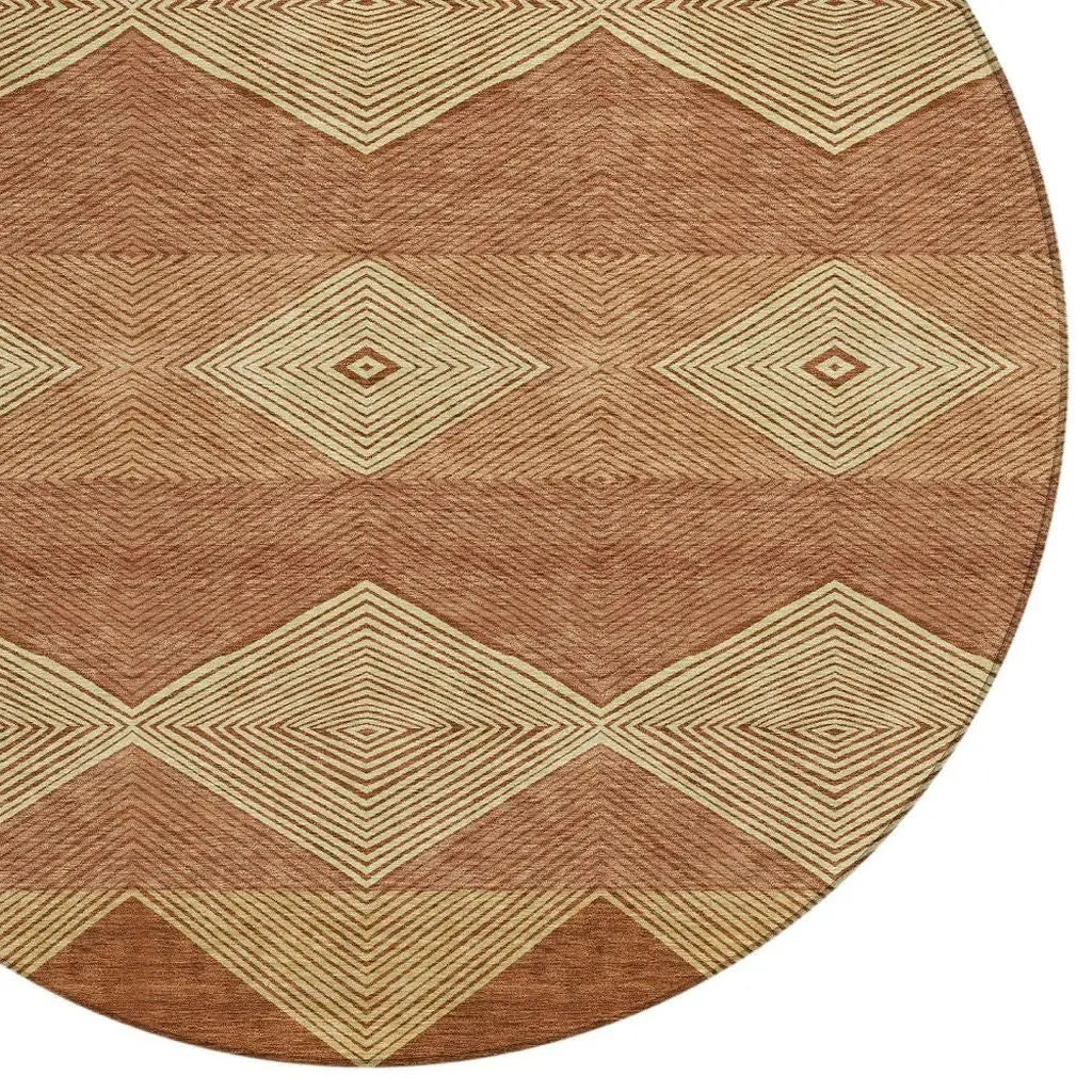 Round geometric area rug in warm terracotta and cream, featuring diamond patterns in a modern bohemian style.