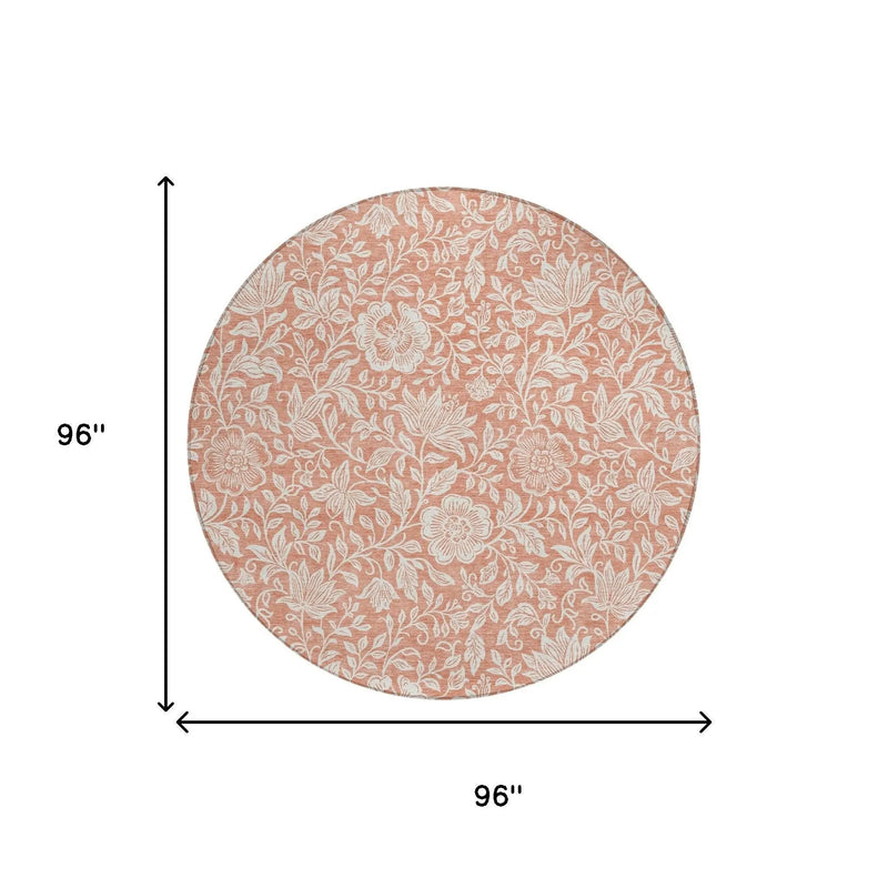 Round cotton tablecloth in soft peach with intricate white floral pattern, 96 inches in diameter. Ideal for elegant dining.
