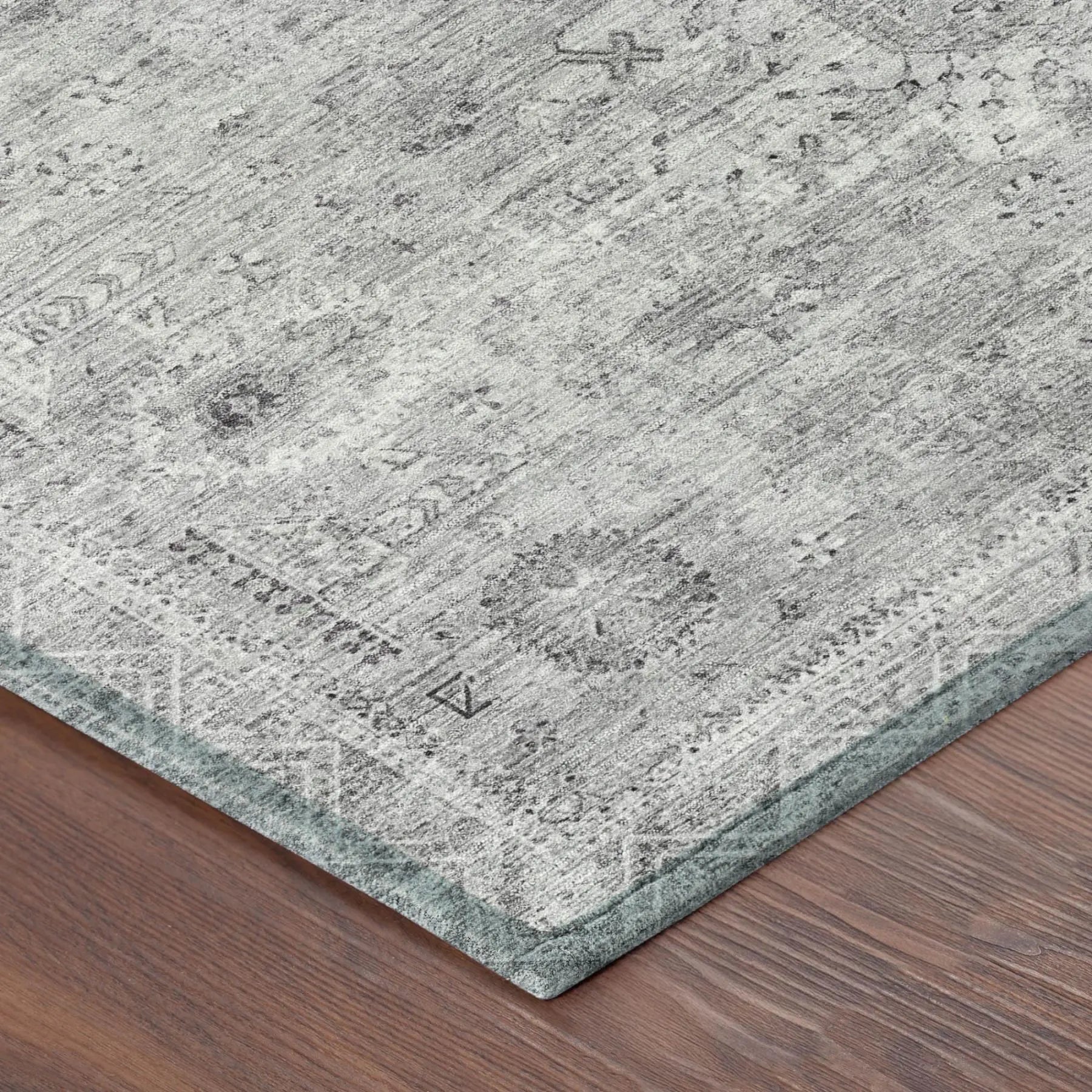 Gray vintage-style area rug with intricate patterns, featuring a soft texture and subtle, muted tones.