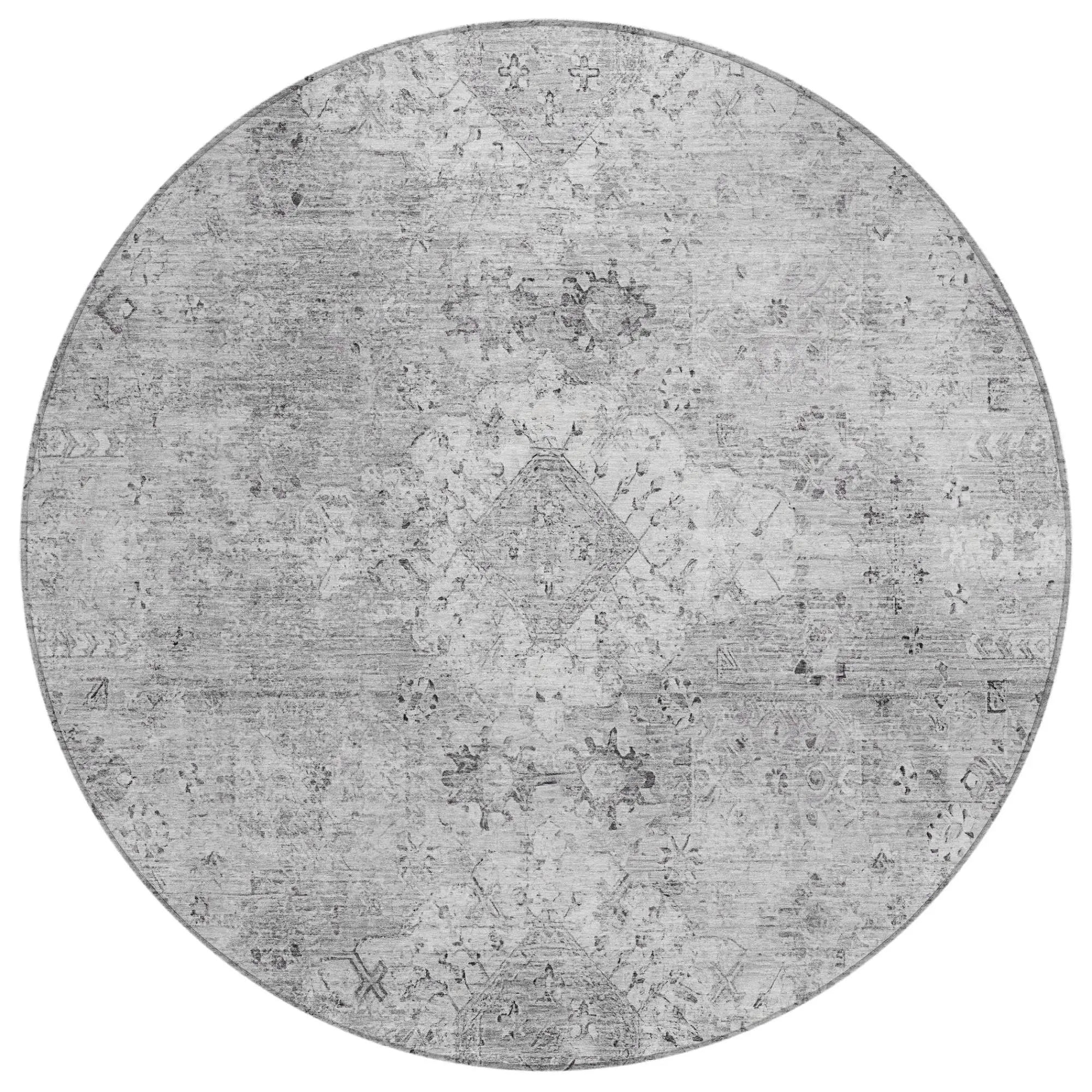 Round vintage-style gray area rug with intricate patterns in faded tones, perfect for modern or classic decor.