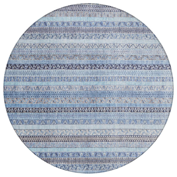 Round blue patterned area rug featuring intricate tribal designs in various shades of blue and subtle gray accents.