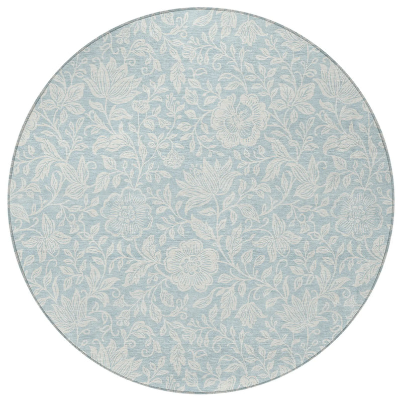 Light blue round rug with floral pattern, made from durable, soft material, perfect for adding a stylish touch to any room.