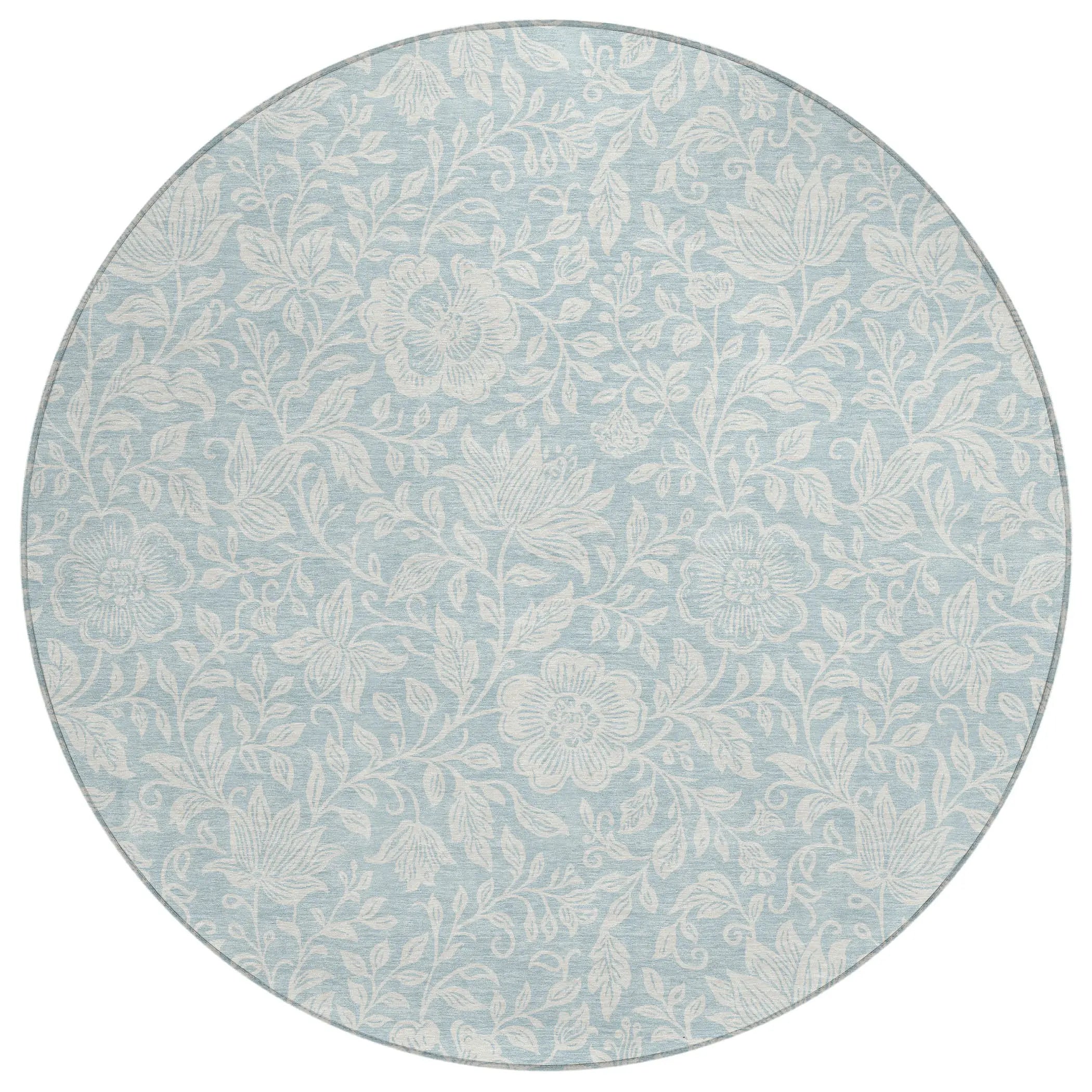 Round light blue floral area rug in soft materials, featuring intricate white botanical patterns for elegant decor.