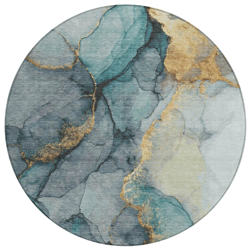 Round area rug in aqua blue, gray, and gold abstract design, made from soft, durable synthetic fibers.