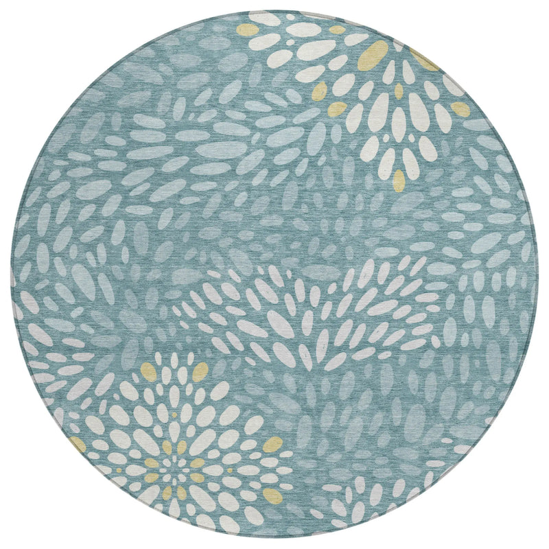 Round blue area rug with floral design in white and yellow, made of durable, soft fabric. Ideal for modern decor.