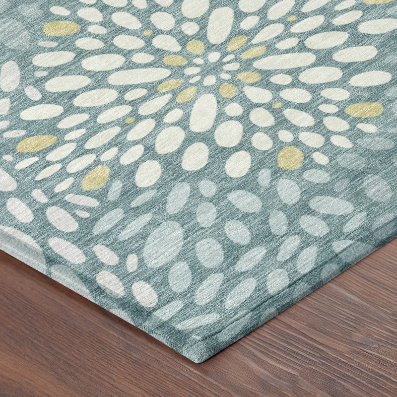 Turquoise area rug with yellow and white floral pattern, crafted from soft, durable material for modern decor.