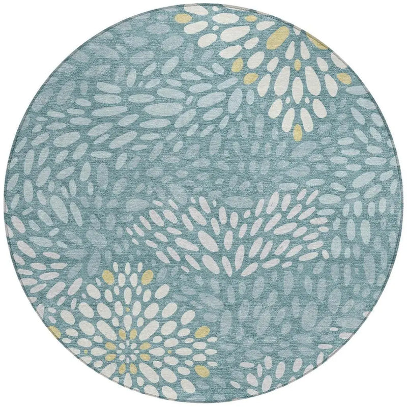 Round blue area rug with abstract floral pattern in white and yellow, made of soft, durable material.