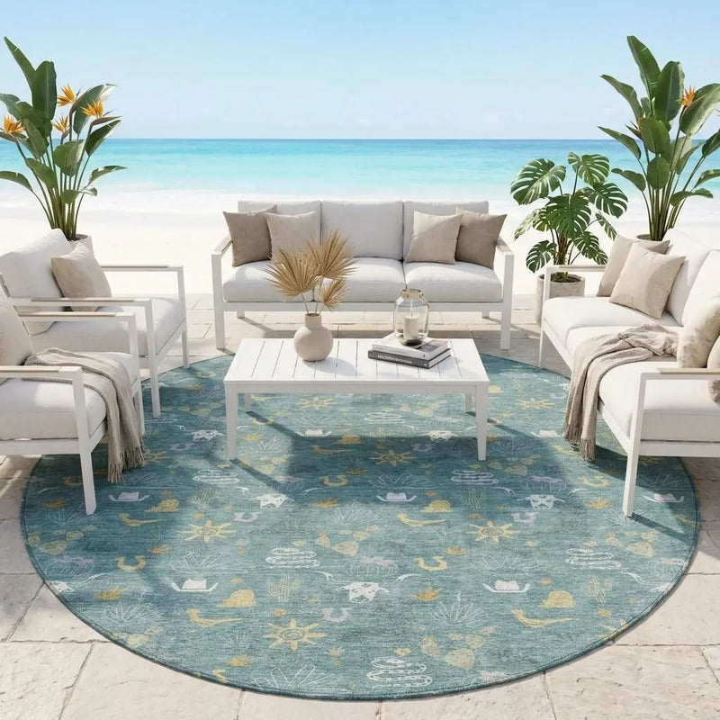 Round blue outdoor rug with nautical patterns, paired with white lounge furniture, set on a beachside patio.