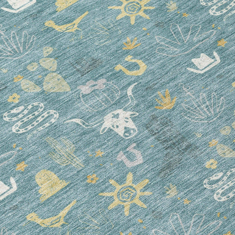 Blue woven area rug with yellow, white, and pink Western-themed patterns, featuring cacti, sun motifs, and animals.