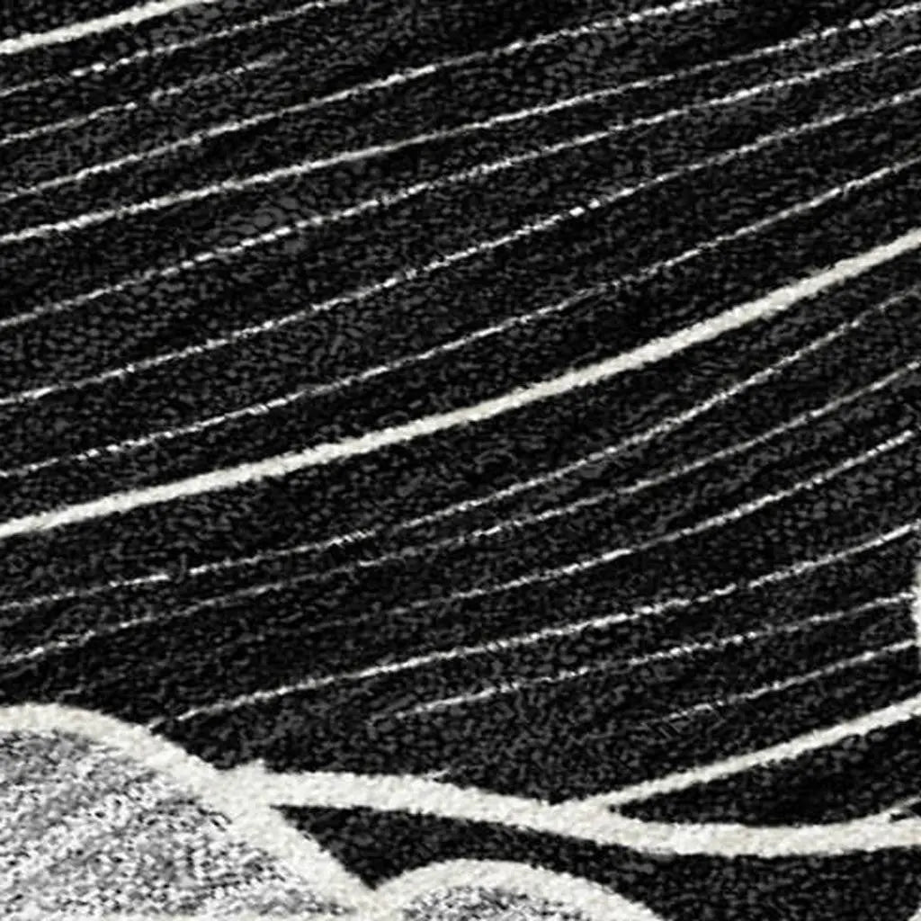 Black and white abstract area rug with textured lines and waves, crafted from durable synthetic fibers.