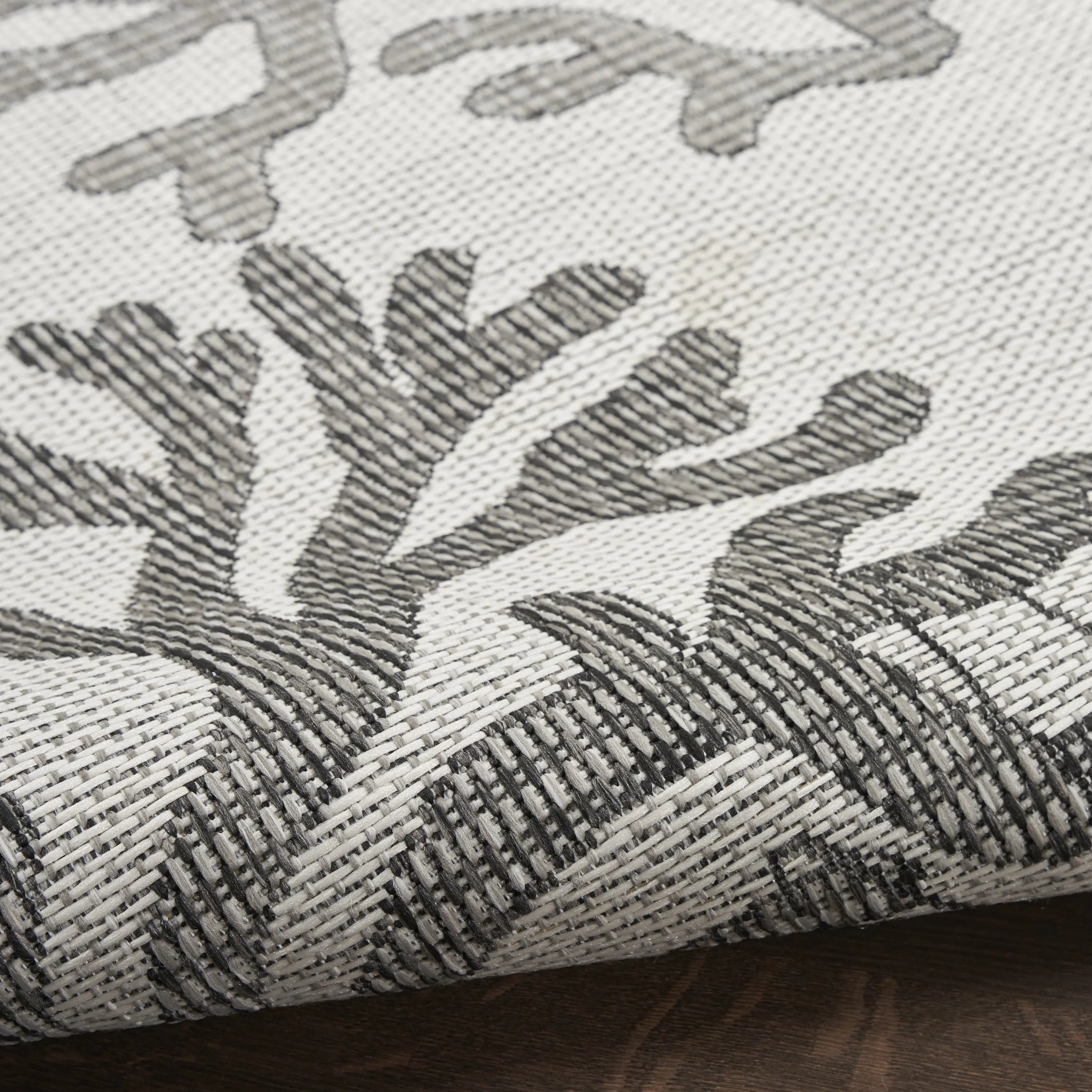 Gray and white woven area rug with coral pattern, perfect for modern decor. Durable, stylish, and versatile design.