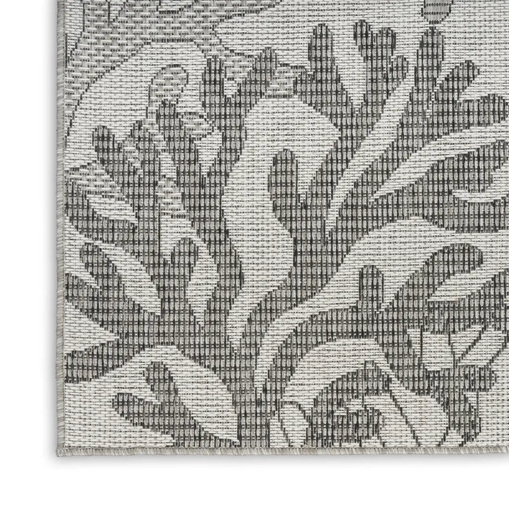 Gray patterned indoor rug made of durable woven fabric, featuring a floral design for modern home decor.
