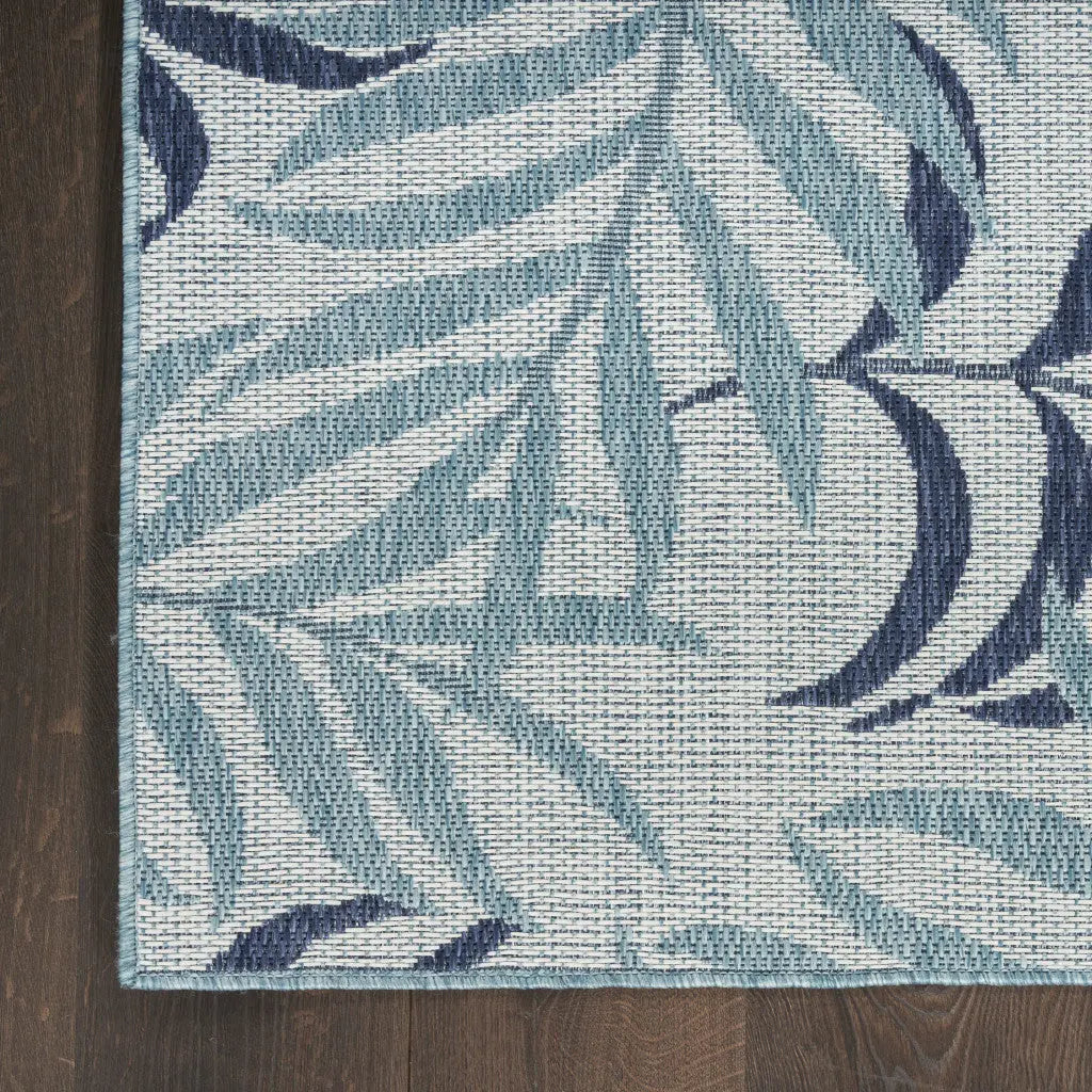 Blue and navy leaf-patterned area rug, woven from durable materials, perfect for enhancing any indoor space.