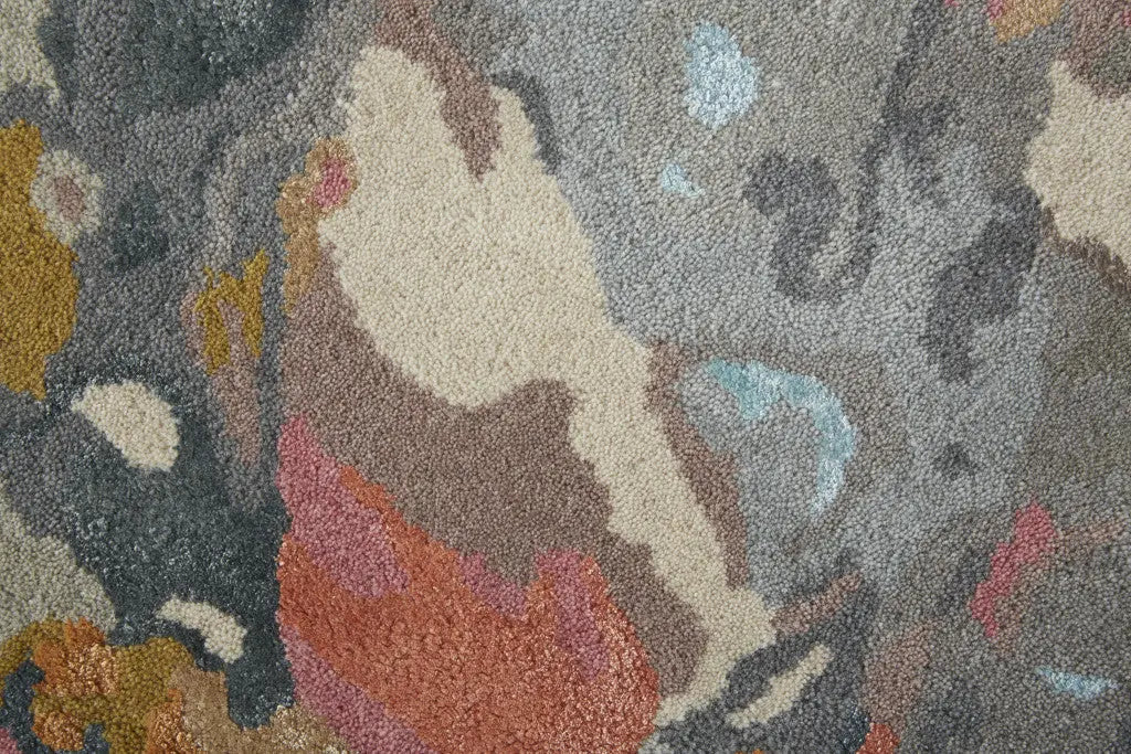 Multicolored abstract area rug in beige, gray, and orange; soft polyester material for living room or bedroom decor.