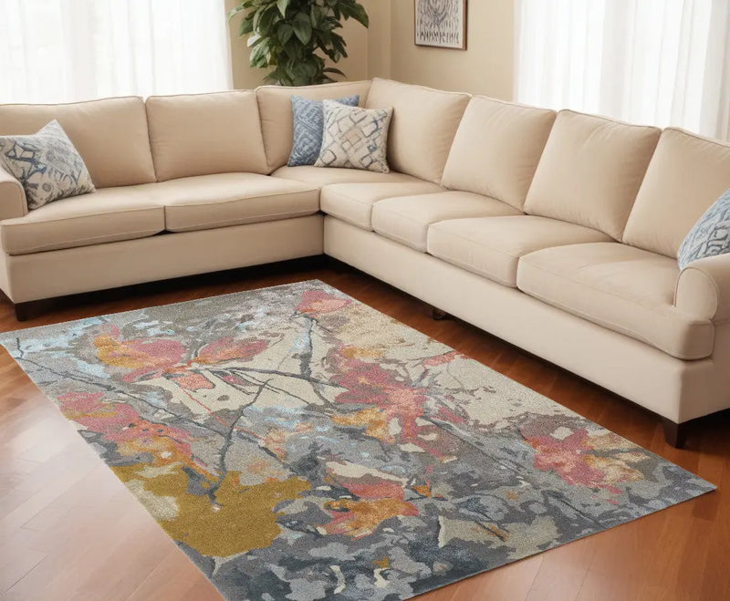 Vibrant floral area rug in blue, orange, and gold tones, ideal for stylish living room decor. Soft, durable materials.