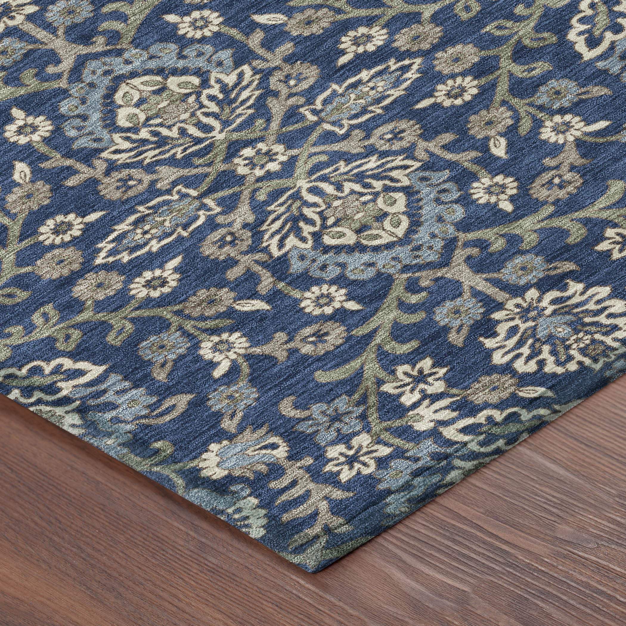 Navy blue area rug with floral pattern in cream and green, crafted from soft, durable materials.