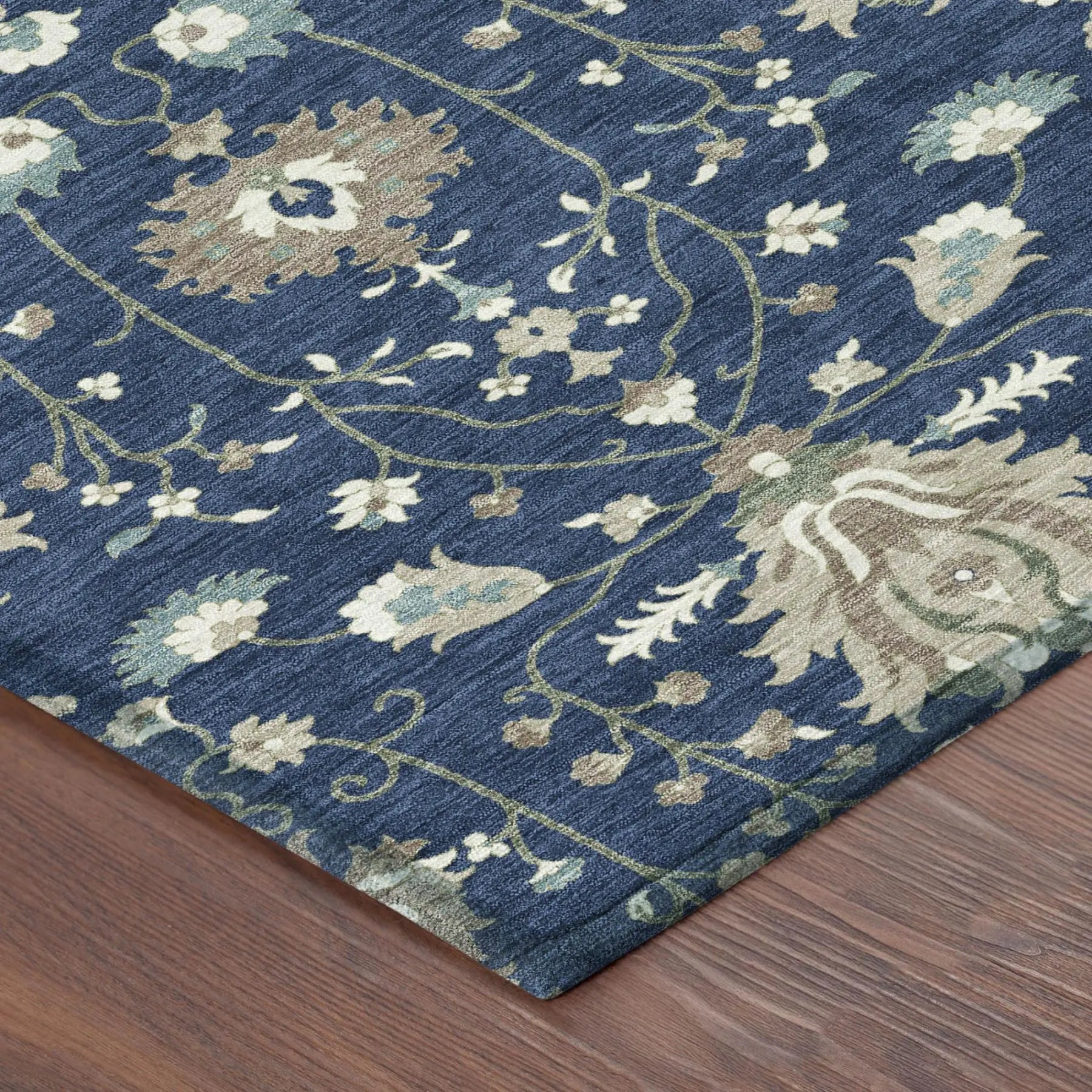 Navy blue floral area rug, featuring intricate ivory and green patterns, soft synthetic fibers, and a modern classic design.