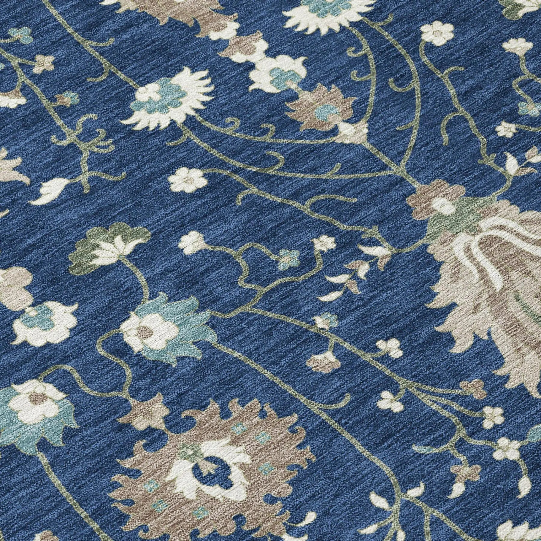 Navy blue floral area rug with beige, light green, and ivory accents; elegant, modern design in soft textile.