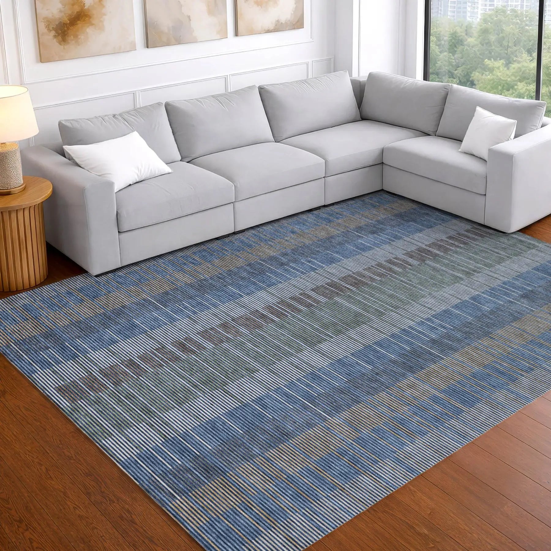 Modern blue striped area rug on hardwood floor, featuring green and gray tones, perfect for a chic living room.