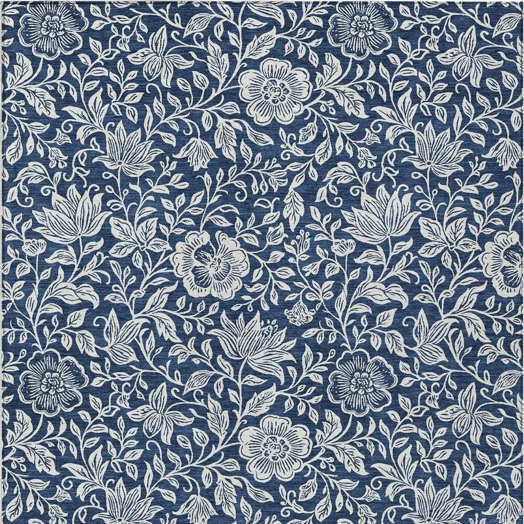 Navy blue floral patterned fabric, featuring intricate white botanical designs, perfect for upholstery or home decor.