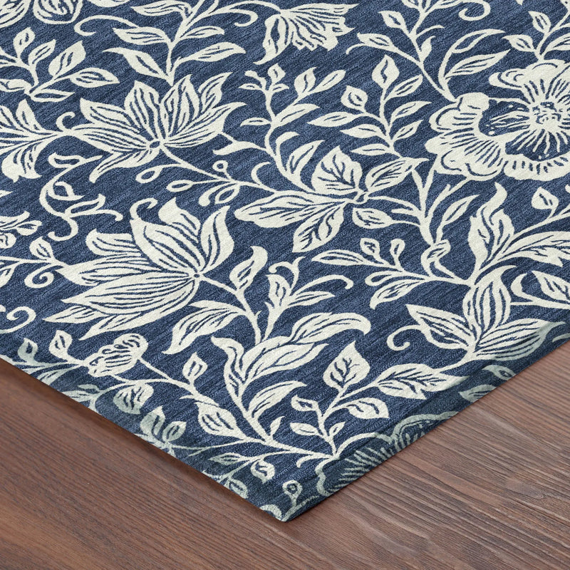 Navy blue floral area rug with ivory botanical design, soft textile, perfect for modern or eclectic decor.