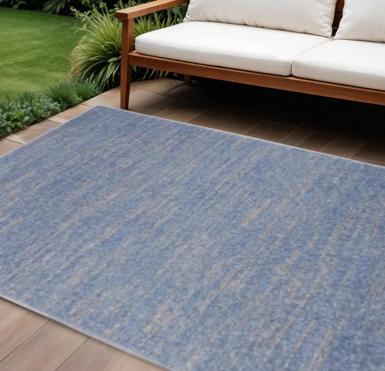 Blue indoor-outdoor rug in a textured weave, perfect for patio or garden with modern style and durable materials.
