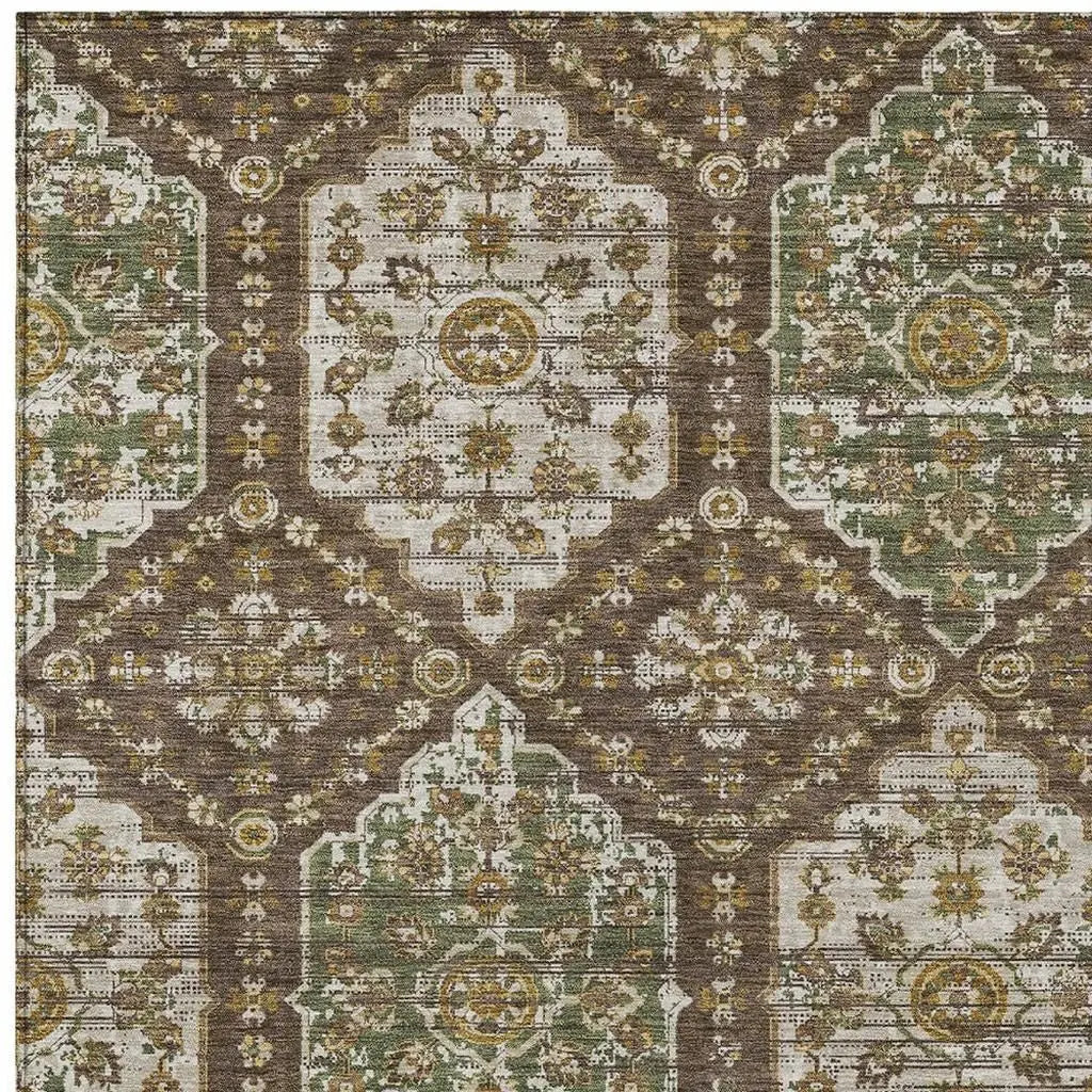 Vintage-inspired area rug in green, gold, and brown with intricate floral patterns, perfect for cozy home decor.