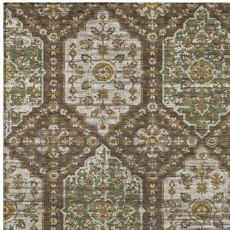 Vintage-inspired area rug in green, gold, and brown with intricate floral patterns, perfect for cozy home decor.