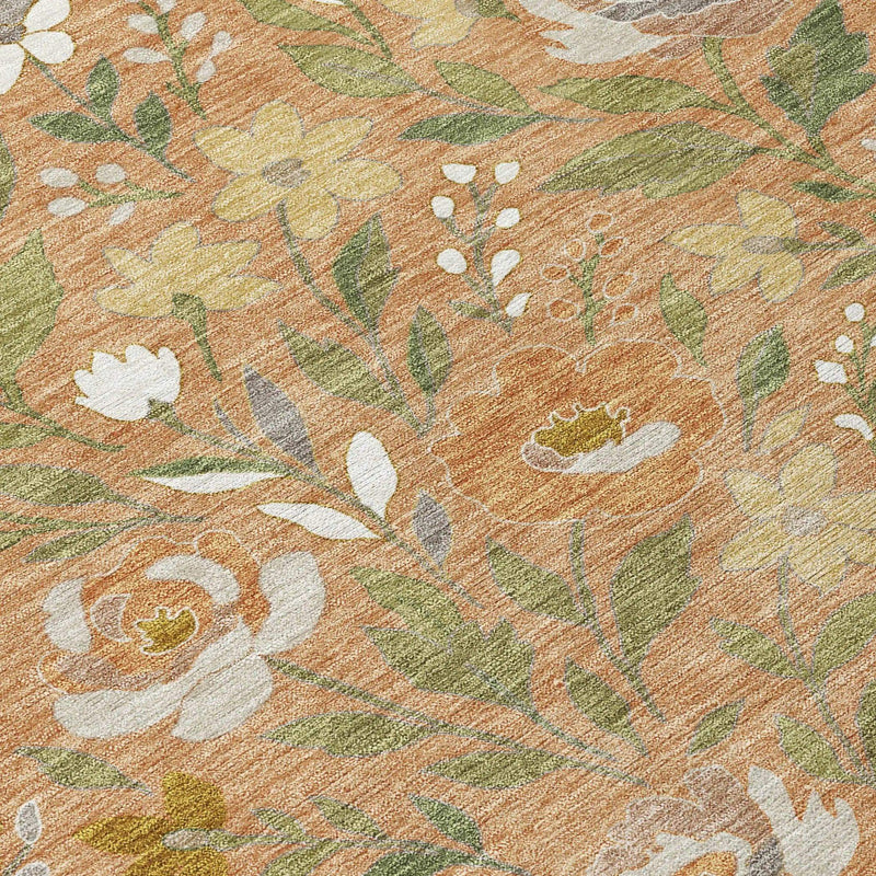 Floral area rug in orange, cream, and green, featuring a soft, textured surface and vibrant botanical patterns.