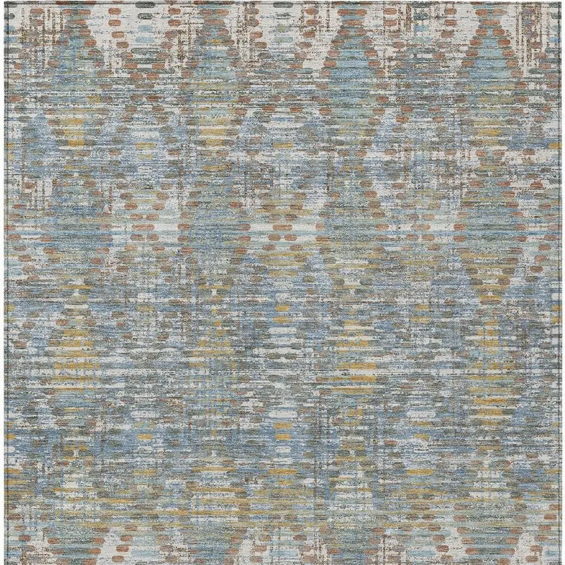 Geometric area rug in blue, beige, and gold tones, featuring a modern abstract design, perfect for contemporary decor.