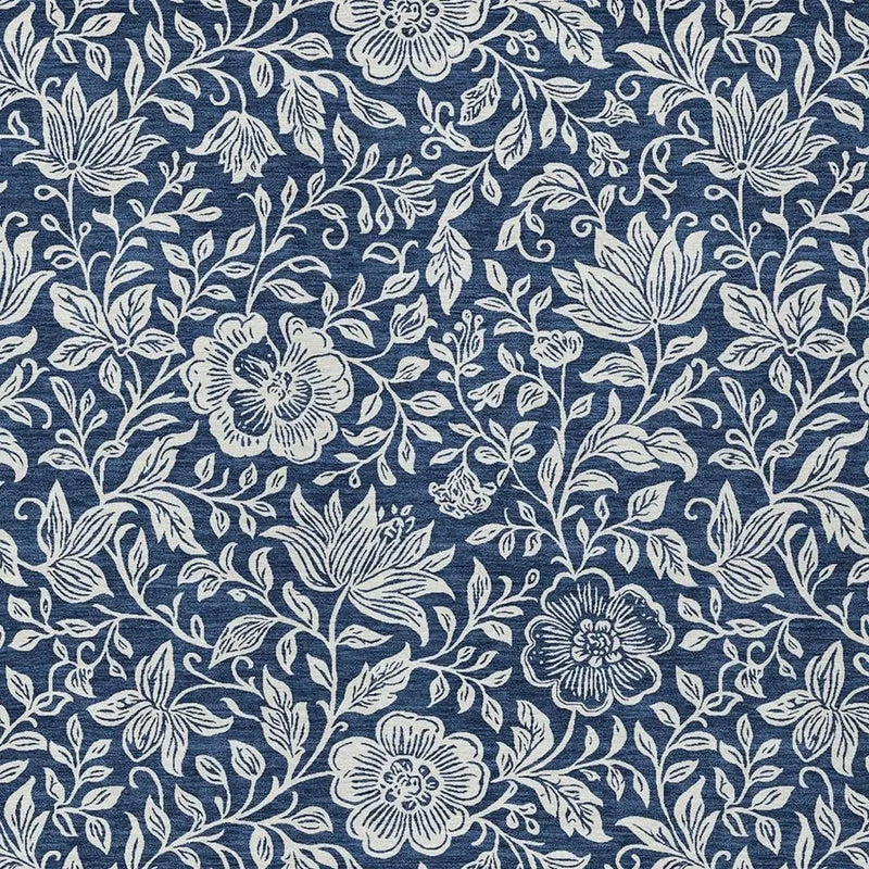 Navy blue floral fabric with white intricate designs, perfect for upholstery or crafting projects.