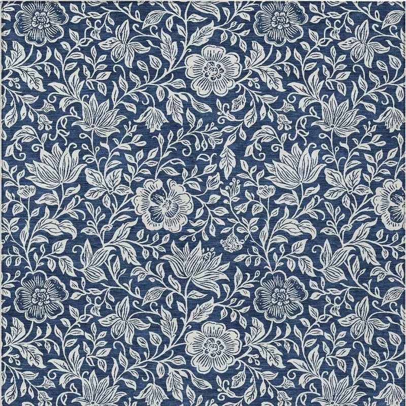 Navy blue floral fabric with white intricate floral and leaf patterns, perfect for upholstery or crafting projects.