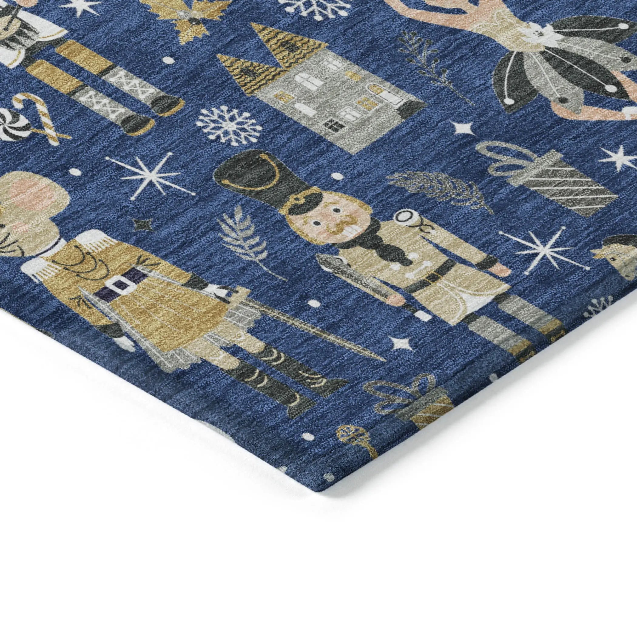 Navy blue patterned fabric featuring nutcracker soldiers, gifts, and winter motifs in gold and silver tones.
