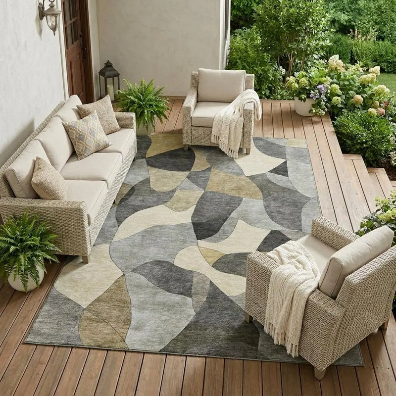 Beige and gray abstract area rug for outdoor seating, featuring soft fibers on a wooden patio with stylish furniture.