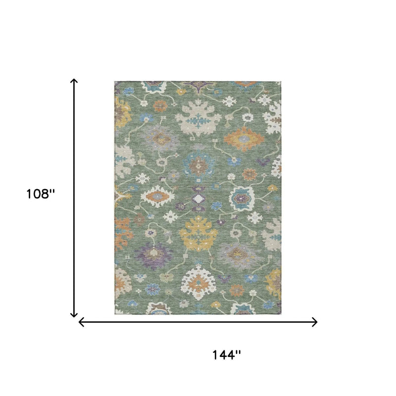 Large rectangular area rug with a green background, intricate floral patterns in blue, orange, and cream. 108" x 144".