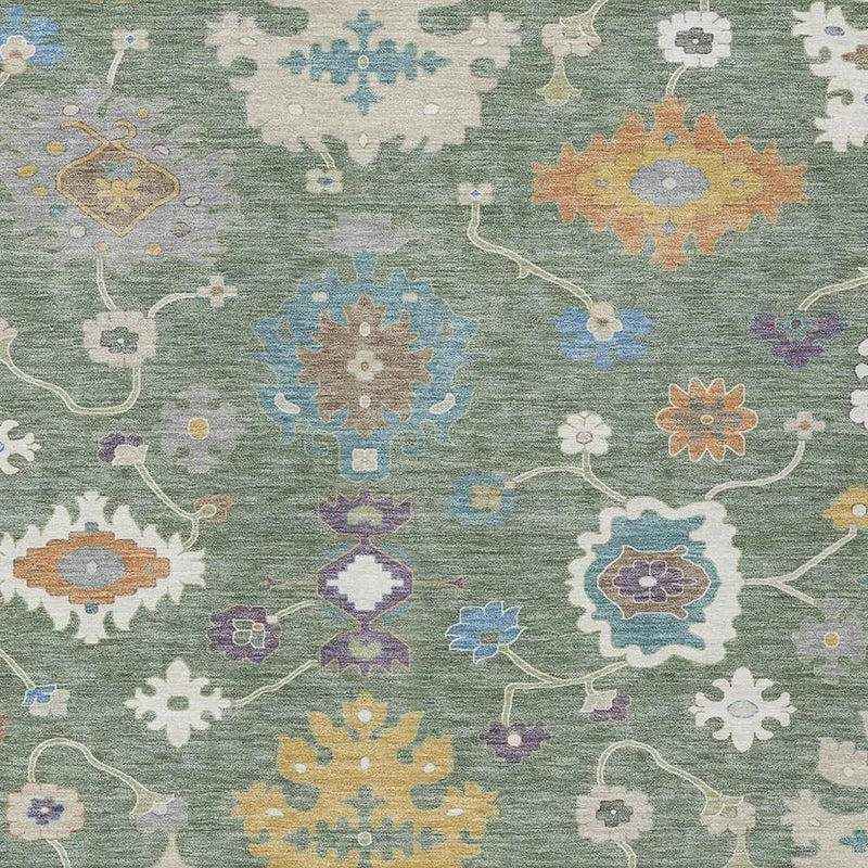 Colorful floral pattern rug with intricate designs in blue, orange, purple, and white on a soft green background.