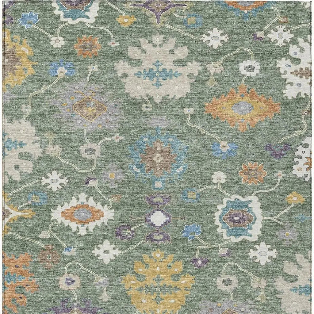 Multicolor floral patterns on a green area rug, featuring intricate designs and a blend of soft fabrics.