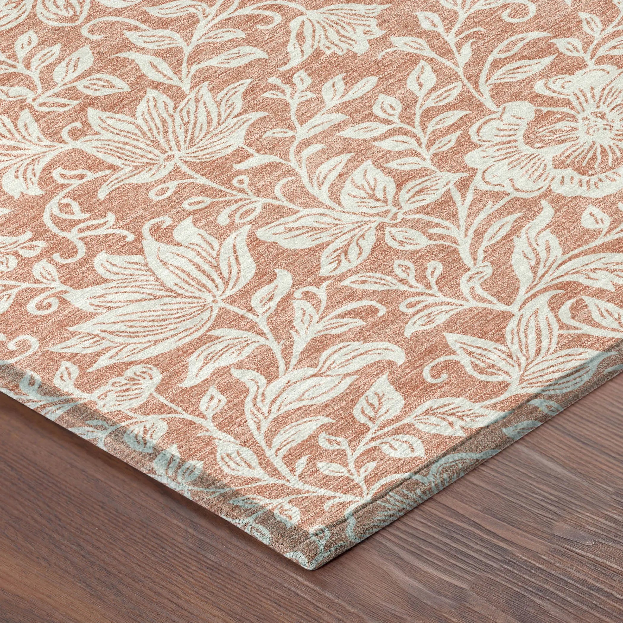 Rust floral pattern area rug in terracotta and cream, soft texture, perfect for enhancing home decor.