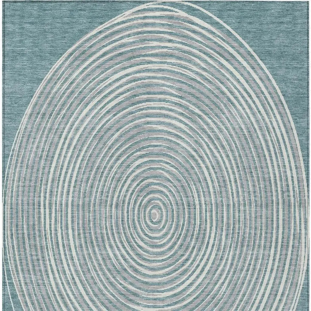Blue area rug with concentric circle pattern in soft beige tones, ideal for modern and contemporary decor.