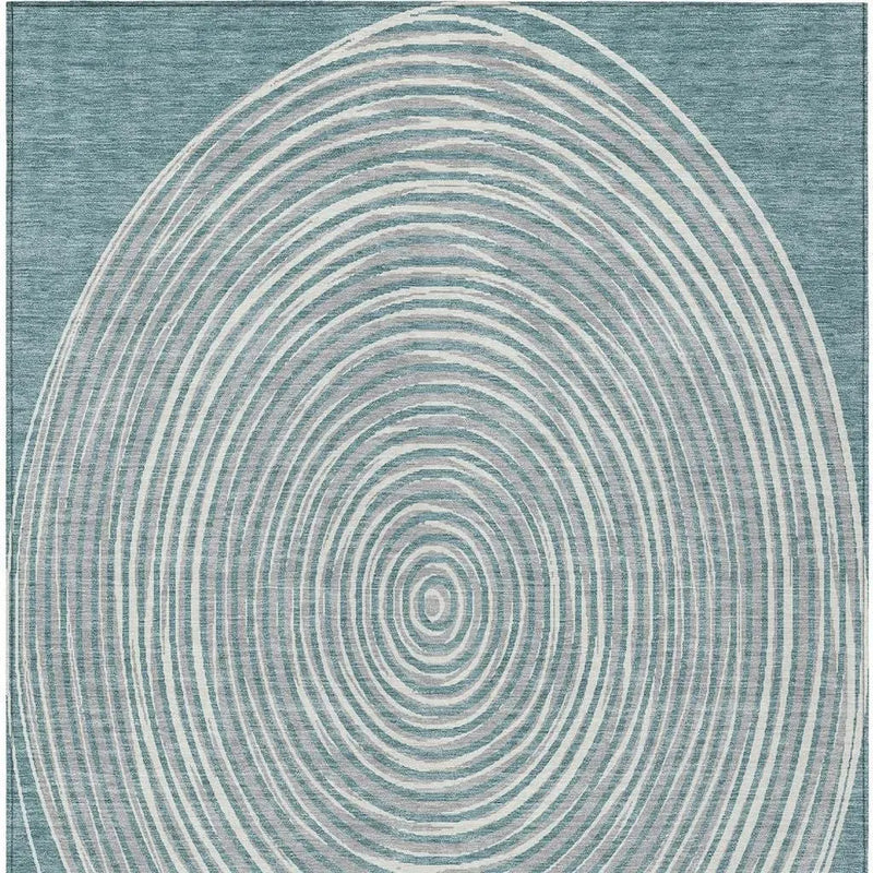 Blue area rug with concentric circle pattern in soft beige tones, ideal for modern and contemporary decor.