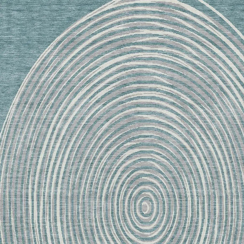 Blue and white abstract rug featuring circular wave patterns, crafted from soft, durable synthetic fibers.