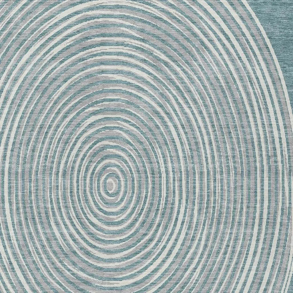 Turquoise and cream patterned area rug with concentric circle design, soft texture, modern style.
