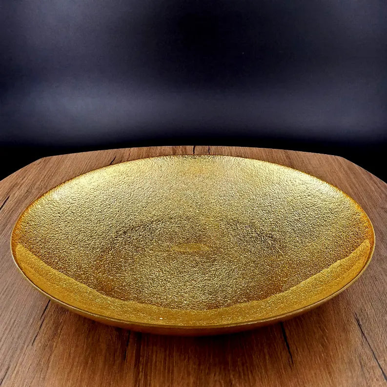 Gold textured serving platter, oval shape, ceramic material, perfect for elegant dining and decor accents.