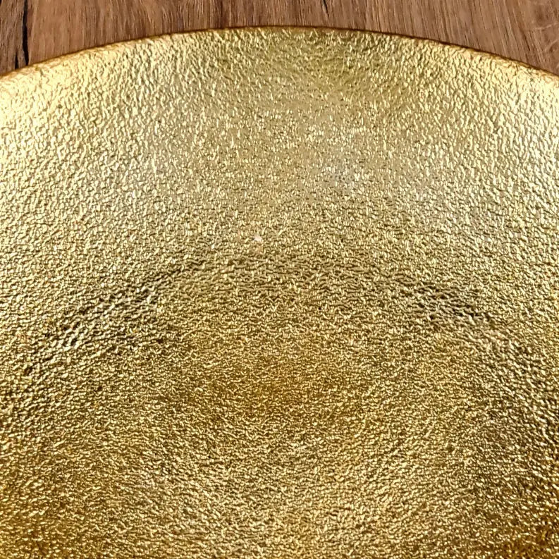 Textured gold round plate, ideal for elegant dining and serving, crafted from durable ceramic with a metallic finish.