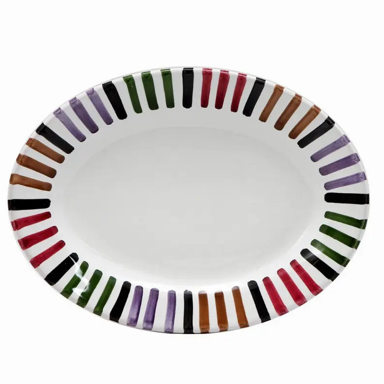 Oval white ceramic platter with colorful striped edge in purple, green, black, orange, and brown. Ideal for serving dishes.