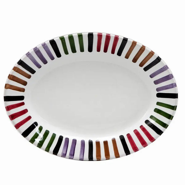 Oval white ceramic platter with colorful striped edge in purple, green, black, orange, and brown. Ideal for serving dishes.