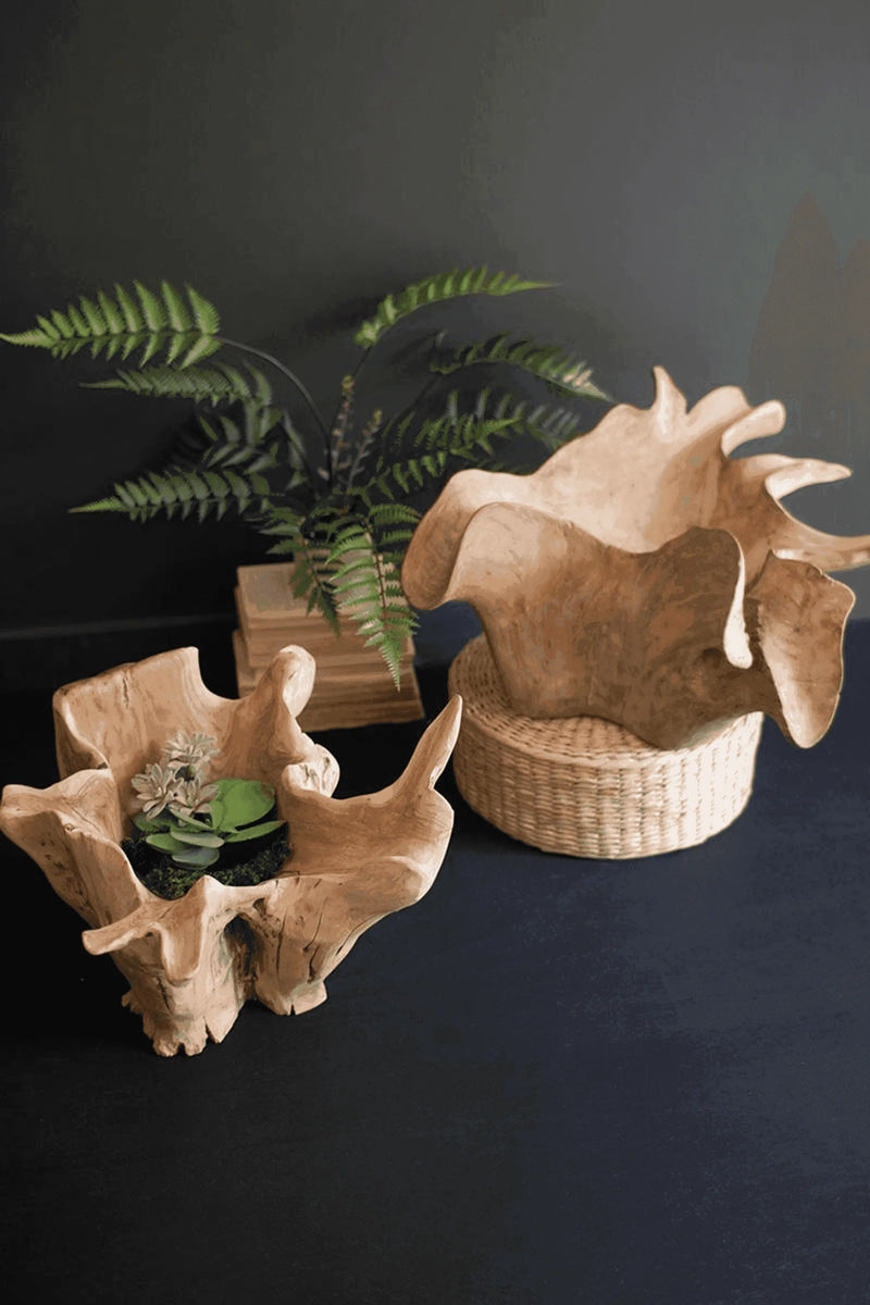Natural wood decorative bowls, light beige, organic shapes, with a woven basket and greenery accents.