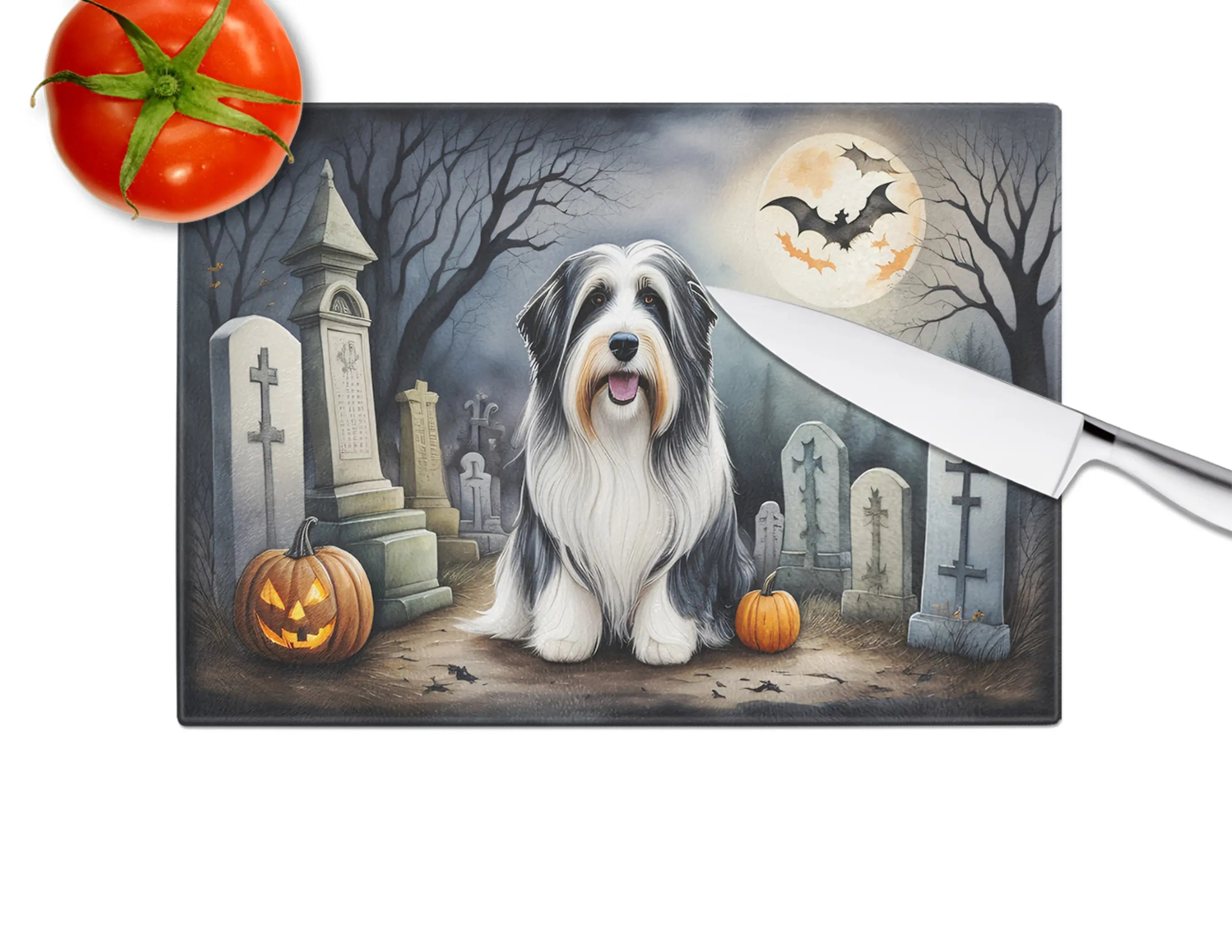 Halloween-themed cutting board featuring a Bearded Collie in a graveyard, with pumpkins, bats, and a full moon.