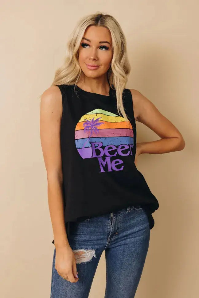 Black sleeveless tank top with colorful sunset "Beer Me" graphic; casual style perfect for summer outings.