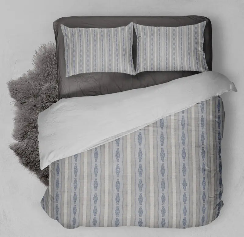 Light blue and cream striped duvet cover set with gray sheets, featuring a modern boho style and soft fabric.